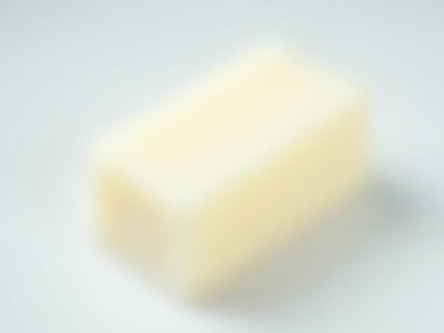 Fragrance-free bar soap on a light wood surface, minimalist packaging.